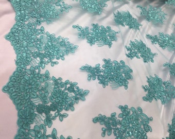 Aqua flower lace corded and embroider with sequins on a mesh. Wedding/bridal/prom/nightgown fabric. Sold by the yard.