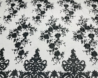 Black flowers flat lace embroider on a 2 way stretch mesh sold by the yard.