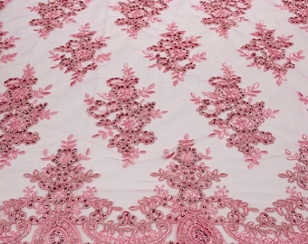 Candy pink corded flowers embroider with sequins on a mesh lace fabric-sold by the yard.