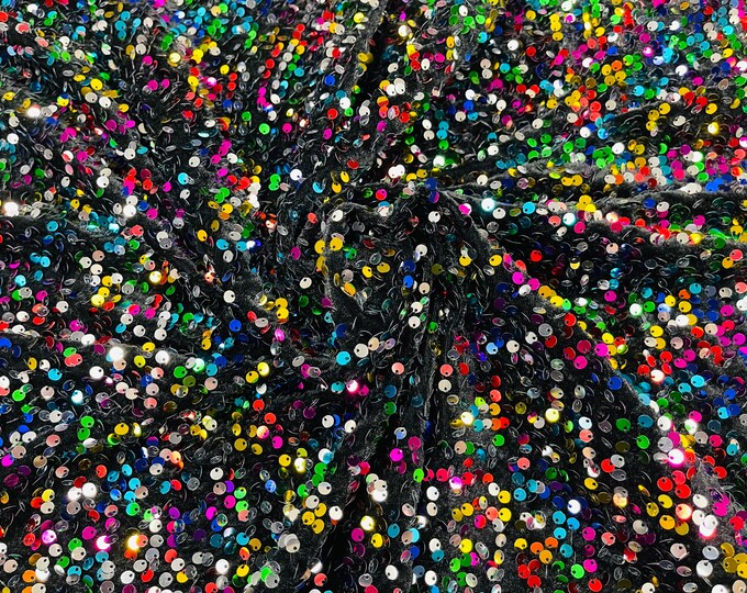 Rainbow economic all over shiny sequins on a 2 way stretch Black velvet , sold by the yard.