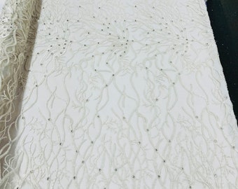 Off white Vine Design Embroider and heavy beading on a mesh lace-sold by the yard.