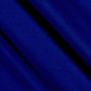 May include: A close-up of a smooth, dark blue fabric with a slight sheen. The fabric is folded in a diagonal pattern, creating a textured look.