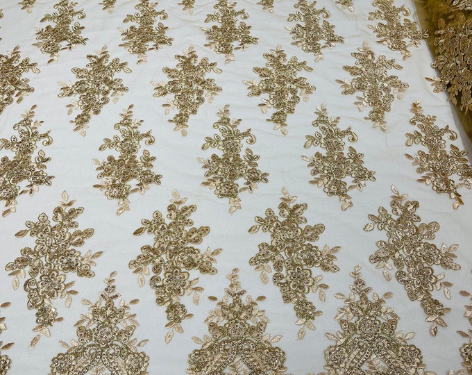 Champagne Gold metallic floral design embroidery on a mesh lace with sequins and cord-sold by the yard.