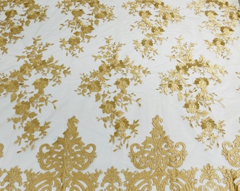 Gold flowers flat lace embroider on a 2 way stretch mesh sold by the yard.