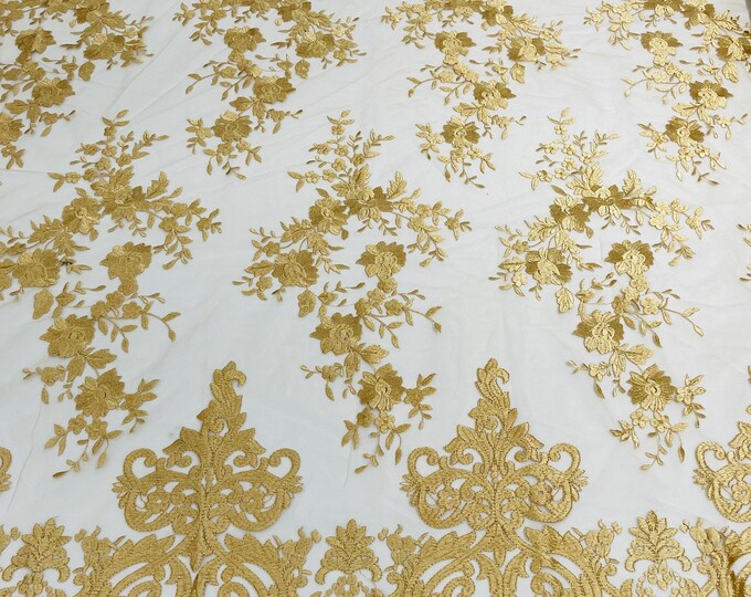 Gold flowers flat lace embroider on a 2 way stretch mesh sold by the yard.