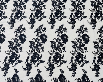 Navy blue floral design embroider and corded on a mesh lace fabric-sold by the yard.