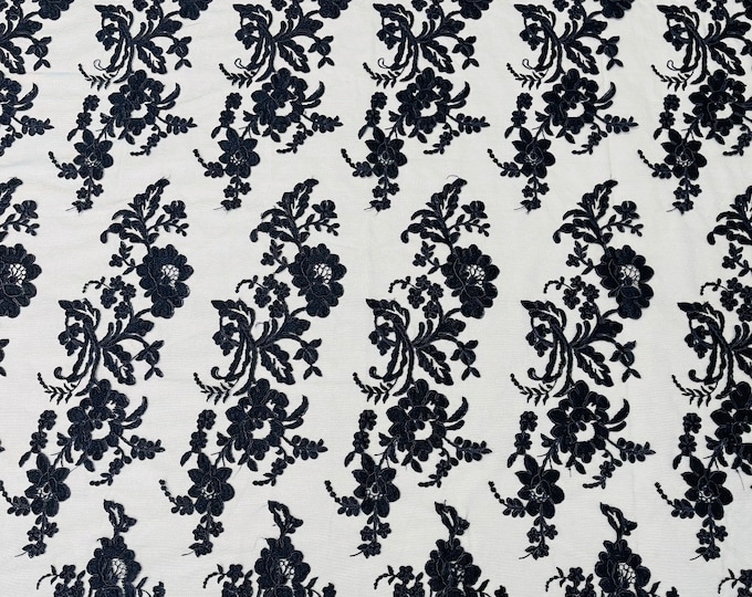 Navy blue floral design embroider and corded on a mesh lace fabric-sold by the yard.