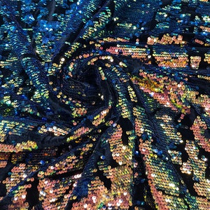 Rainbow/Royal Blue iridescent sequins flip two tone camouflage  design on a black stretch velvet, Sold by the yard.