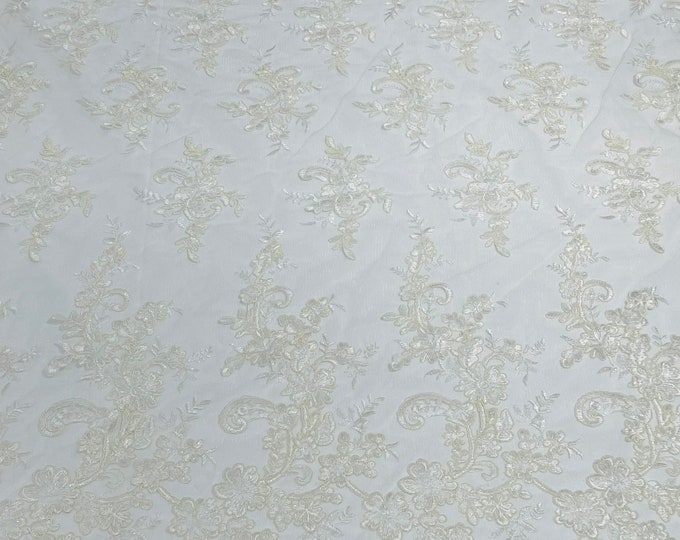 Ivory Gomez Floral design corded embroider with sequins on a mesh lace fabric-sold by the yard.