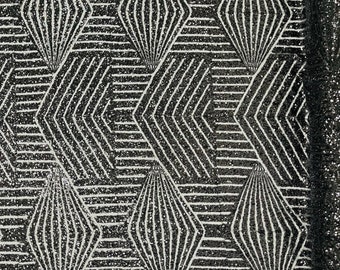 Black geometric sequins design embroider on a 4 way stretch black mesh fabric. Sold by the yard.