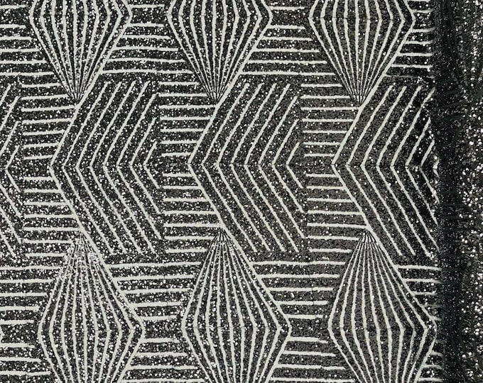 Black geometric sequins design embroider on a 4 way stretch black mesh fabric. Sold by the yard.