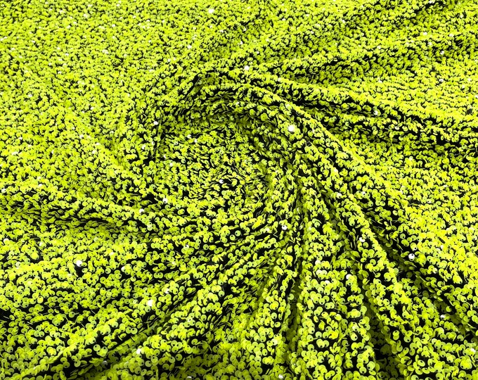 Neon green 5mm sequins on a black stretch velvet 2-way stretch, sold by the yard.