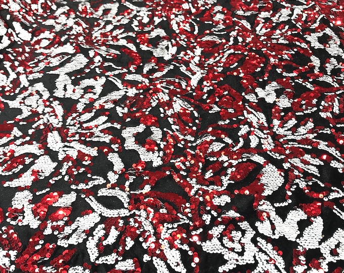 Red, white sequins flip two tone floral design on a black stretch velvet, Sold by the yard.