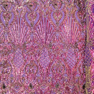 May include: Purple iridescent fabric with a pink and gold sequin pattern. The fabric has a damask design with a repeating pattern of leaves and flowers.