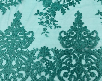 Teal Green flowers flat lace embroider on a 2 way stretch mesh sold by the yard.