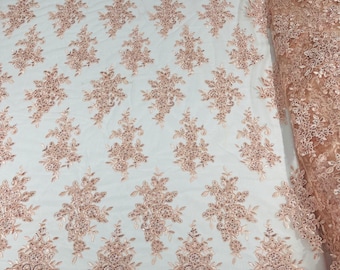 Blush Pink floral design embroidery on a mesh lace with sequins and cord-sold by the yard.