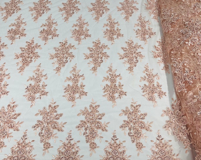 Blush Pink floral design embroidery on a mesh lace with sequins and cord-sold by the yard.