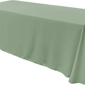 May include: A sage green rectangular tablecloth. The tablecloth is made of a smooth, wrinkle-resistant fabric.