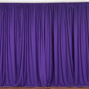May include: A solid purple backdrop made of fabric. The backdrop is smooth and wrinkle-free, with a slight sheen. It is perfect for photography or as a stage curtain.