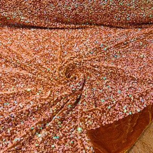 Orange iridescent 5mm sequins on a Orange stretch velvet 2-way stretch, sold by the yard.