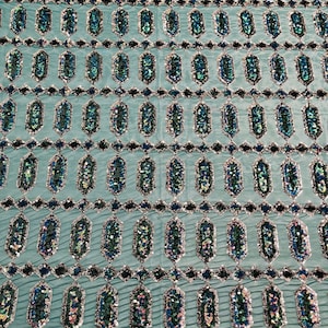 Green/Blue iridescent Jewel sequin design on a green 4 way stretch mesh fabric -sold by the yard.