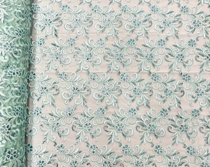 Mint corded flowers embroider with sequins on a mesh lace fabric-sold by the yard-
