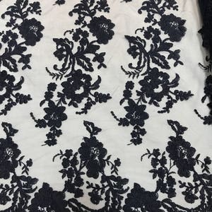 NAVY BLUE FLORAL DESIGN WITH CORD EMBROIDERY ON A MESH LACE-SOLD BY YARD. main image 0