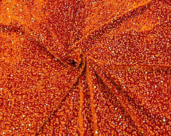 Orange Iridescent economic all over shiny sequins on a 2 way stretch Burt orange velvet , sold by the yard.