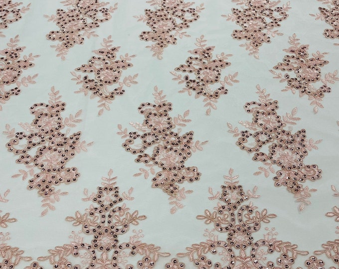 Blush pink corded flowers embroider with sequins on a mesh lace fabric-sold by the yard.
