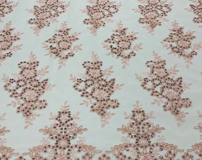 Blush pink corded flowers embroider with sequins on a mesh lace fabric-sold by the yard.