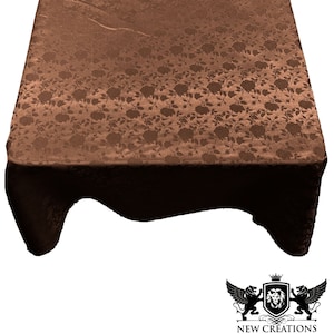 May include: A brown tablecloth with a floral pattern. The tablecloth is made of a soft, silky fabric and has a subtle sheen.