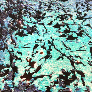 Aqua/ Silver iridescent sequins flip two tone camouflage  design on a black stretch velvet, Sold by the yard.