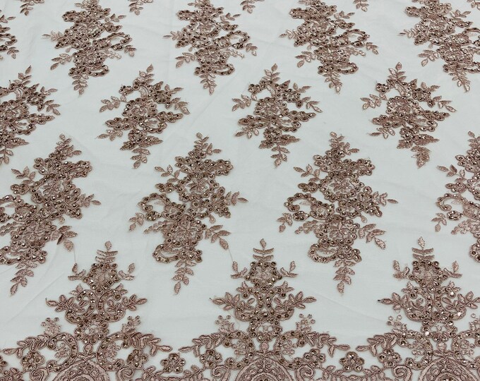 Mauve corded flowers embroider with sequins on a mesh lace fabric-sold by the yard.