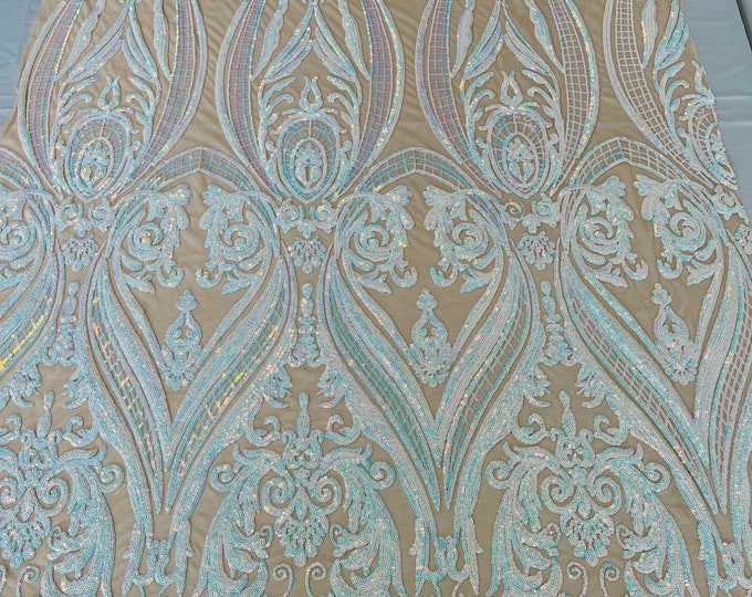 Clear aqua iridescent empire damask design with sequins embroider on a nude 4 way stretch mesh fabric-sold by the yard.