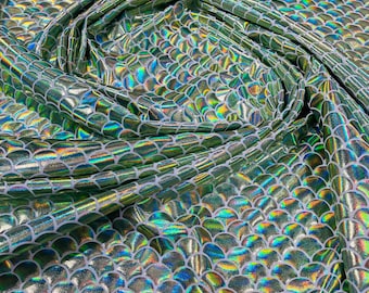 Mint green iridescent mermaid fish scales on a white stretch spandex-sold by the yard.