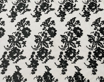 Black floral design embroider and corded on a mesh lace fabric-sold by the yard.
