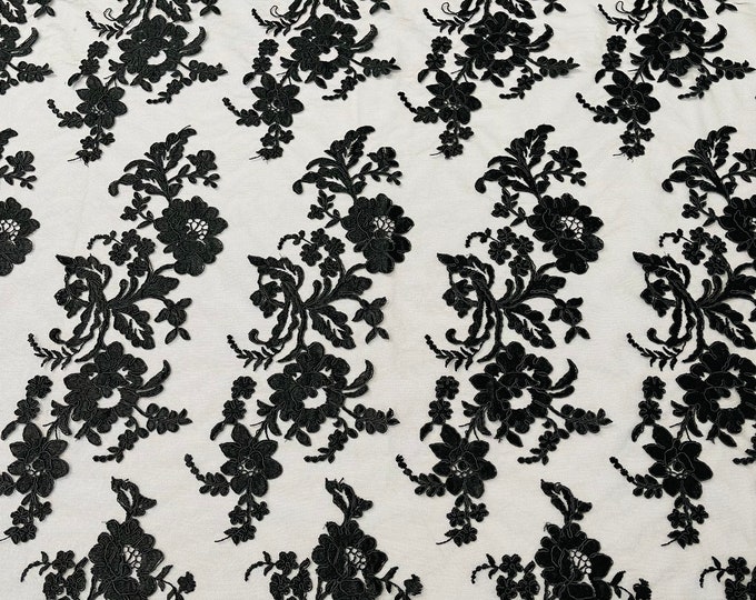 Black floral design embroider and corded on a mesh lace fabric-sold by the yard.