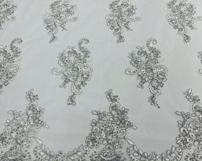 Metallic silver white flower lace corded and embroider with sequins on a mesh-Sold by the yard.