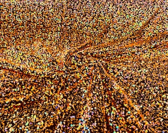 Clear orange iridescent 5mm sequins on a black stretch velvet 2-way stretch, sold by the yard.