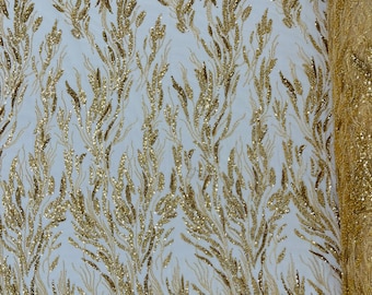 Gold Fancy Design Embroider and heavy beading on a mesh lace-sold by the yard.