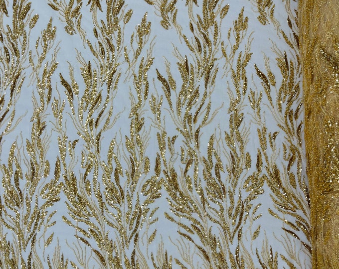 Gold Fancy Design Embroider and heavy beading on a mesh lace-sold by the yard.