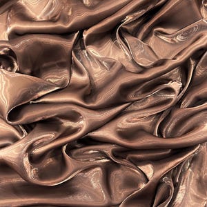 May include: Close-up of a luxurious, flowing fabric in a rich, warm brown hue. The material has a subtle sheen, with light reflecting off the folds and curves, creating highlights and shadows. The fabric appears soft and pliable, suggesting it could be used for apparel or home decor.