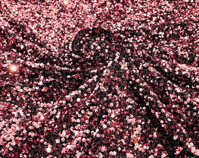 dusty rose 5mm sequins on a black stretch velvet 2-way stretch, sold by the yard.