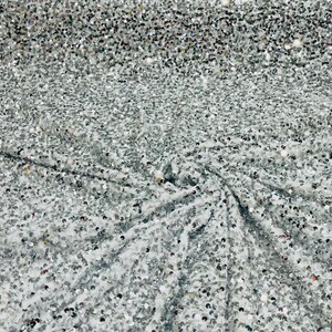 Silver 5mm sequins on a white stretch velvet 2-way stretch, sold by the yard.