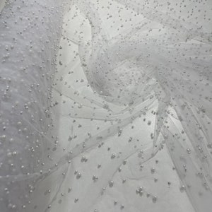 White Heavy Scattered Pearls Studded Mesh, 2-Way Stretch, sold by the yard.