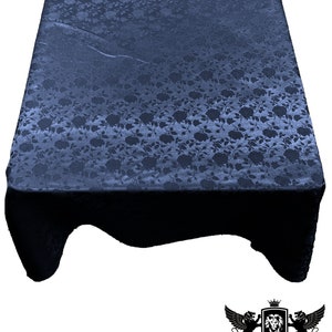 May include: A dark blue tablecloth with a floral pattern. The tablecloth is made of a satin-like material and has a slight sheen.