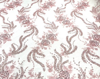Pink flowers embroider and heavy beaded on a mesh lace fabric-sold by the yard.