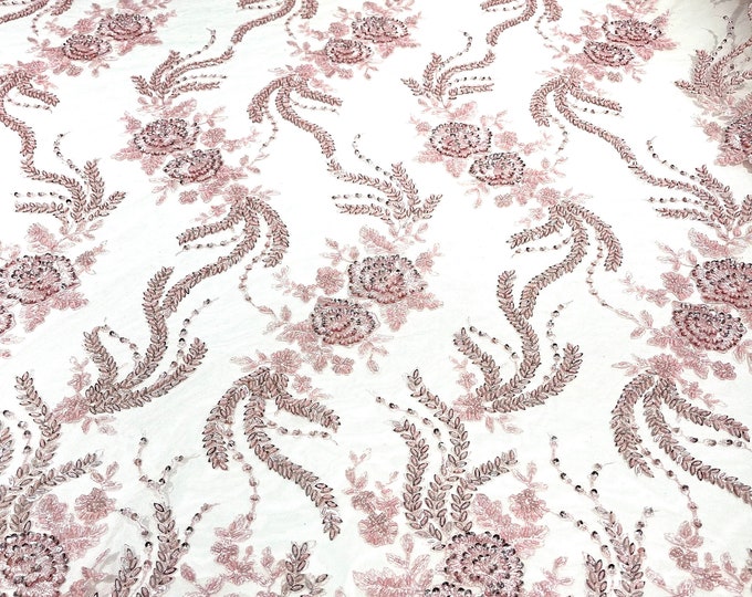 Pink flowers embroider and heavy beaded on a mesh lace fabric-sold by the yard.