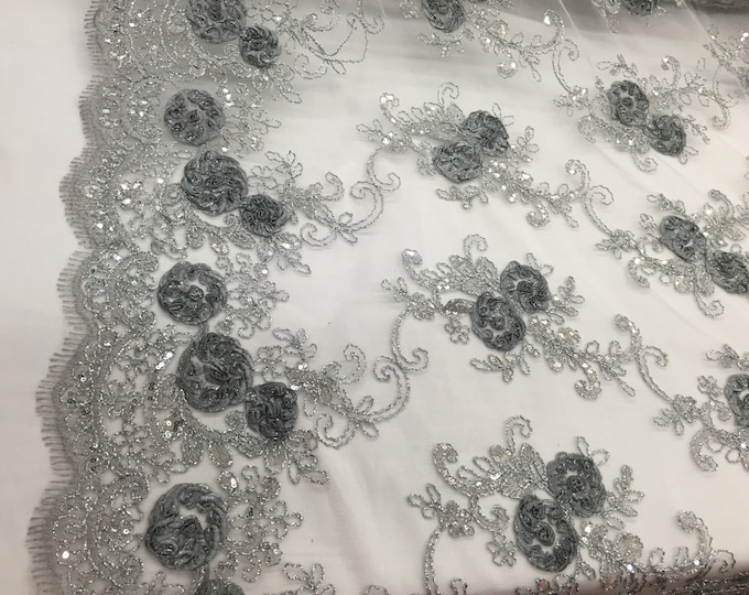 Gray/silver 3d flowers embroider with sequins on a silver mesh lace. Wedding/bridal/prom/nightgown fabric. Sold by the yard.