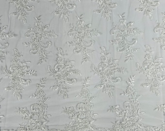 White Lex floral design corded and embroider with sequins on a mesh lace fabric-prom-sold by the yard.